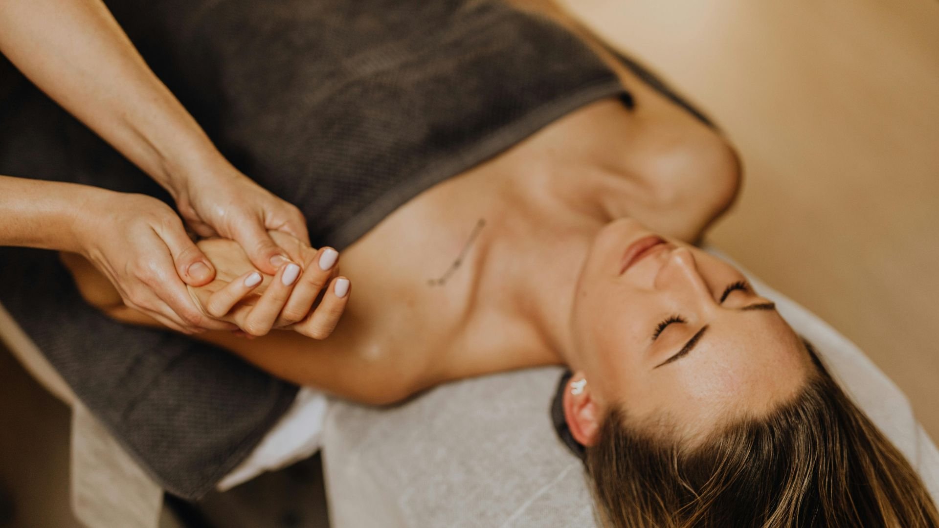 Person receiving a relaxing hand massage at a spa or wellness center