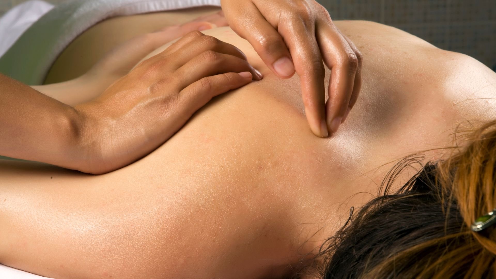 Professional massage therapist provides relaxing back treatment